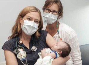 Rebecca Scharf, MD, and Anna Jesus, MD, with the first Virginia baby diagnosed with SMA via a mandatory newborn screening