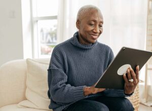 older woman holding tablet