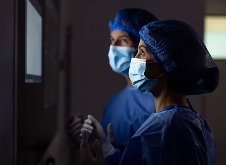 2 surgeons look at a screen together