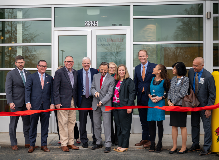 Children's hospital and local leaders cut the red ribbon in front of the new UVA Health Children's neurodevelopmental center