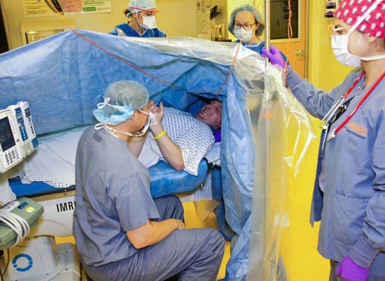 The team interacts with a patient during an awake craniotomy