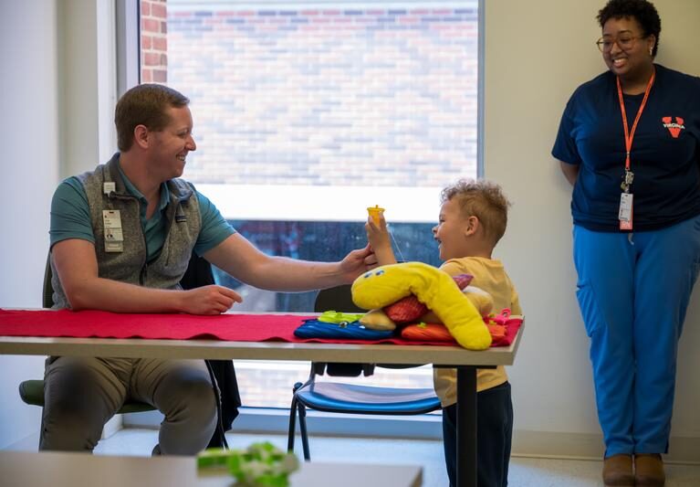 Pediatric patient high-fives a provider